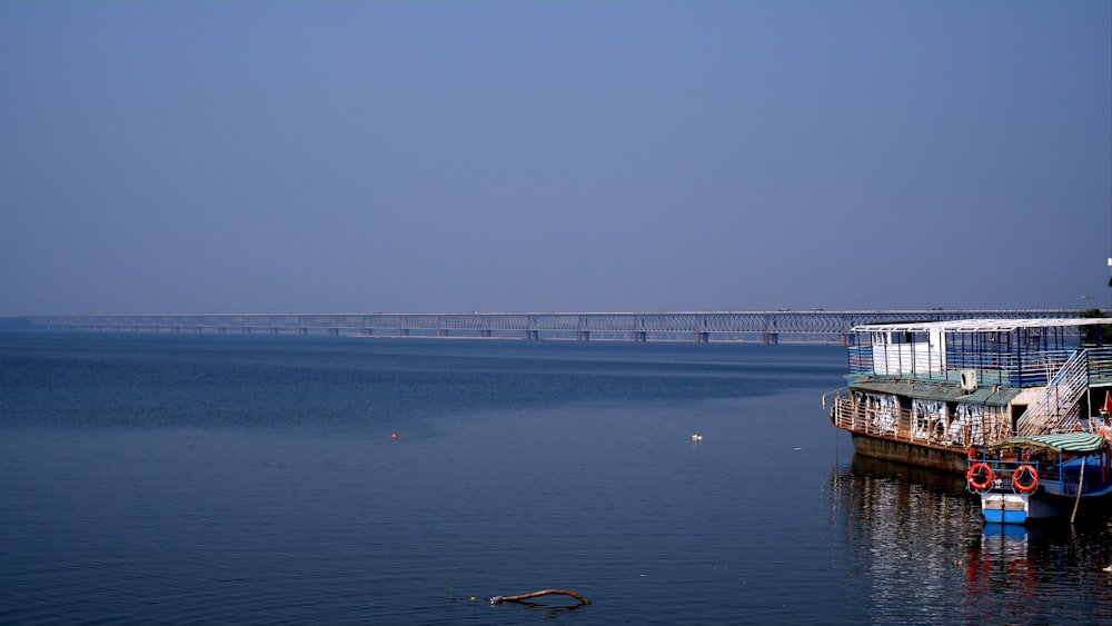 a large body of water with a bridge in the background