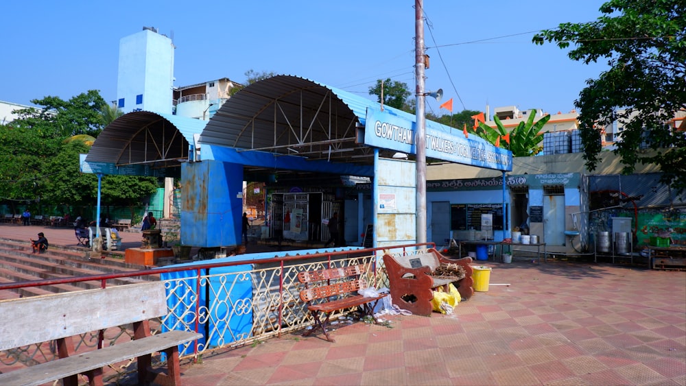 a blue building with a red fence around it