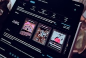 A close-up view of an iPad screen displaying an application interface in dark mode, featuring text in Russian and several graphics related to the app. The screen includes sections for ratings, language, size, and version history. There are preview images showcasing artistic designs and animations.