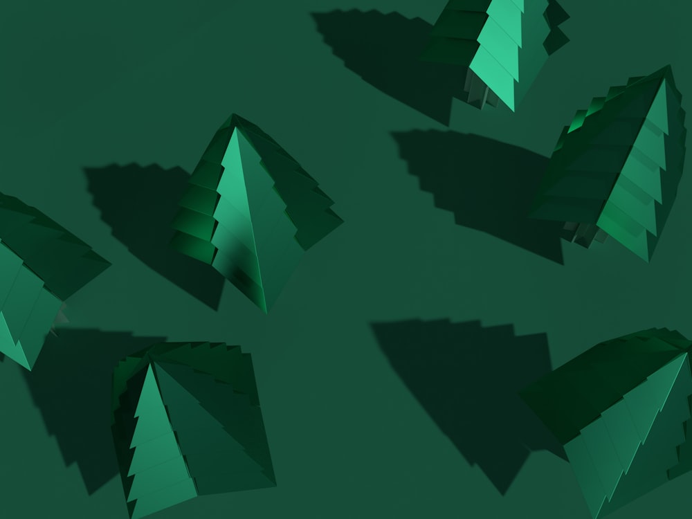 a group of cut out christmas trees on a green background