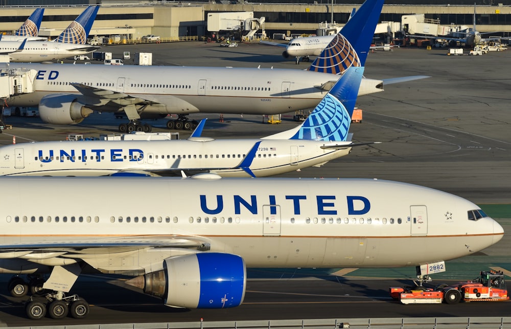 a couple of airplanes that are on a runway