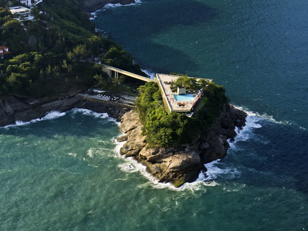 an aerial view of an island with a swimming pool