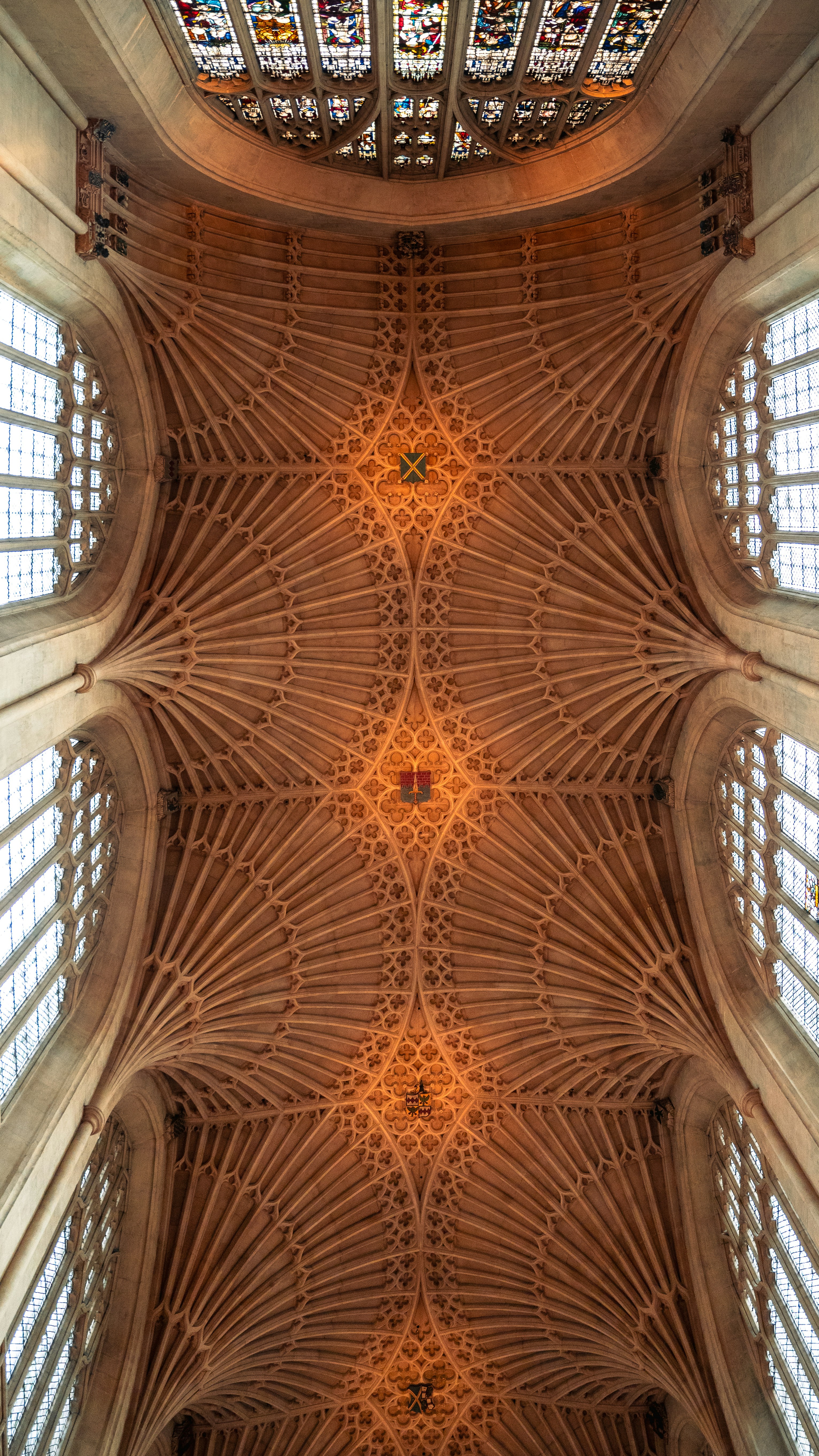 the ceiling of a cathedral with stained glass windows