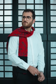a man in a white shirt and red tie