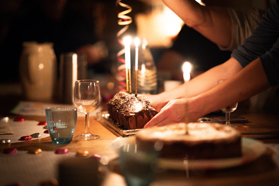 A warm, inviting kitchen scene with a freshly baked artisanal cake on a rustic wooden table surrounded by soft natural light.