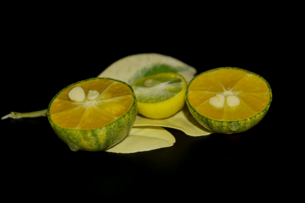 a couple of slices of fruit sitting on top of a leaf