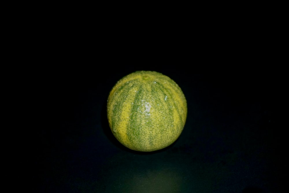 a close up of an orange on a black background