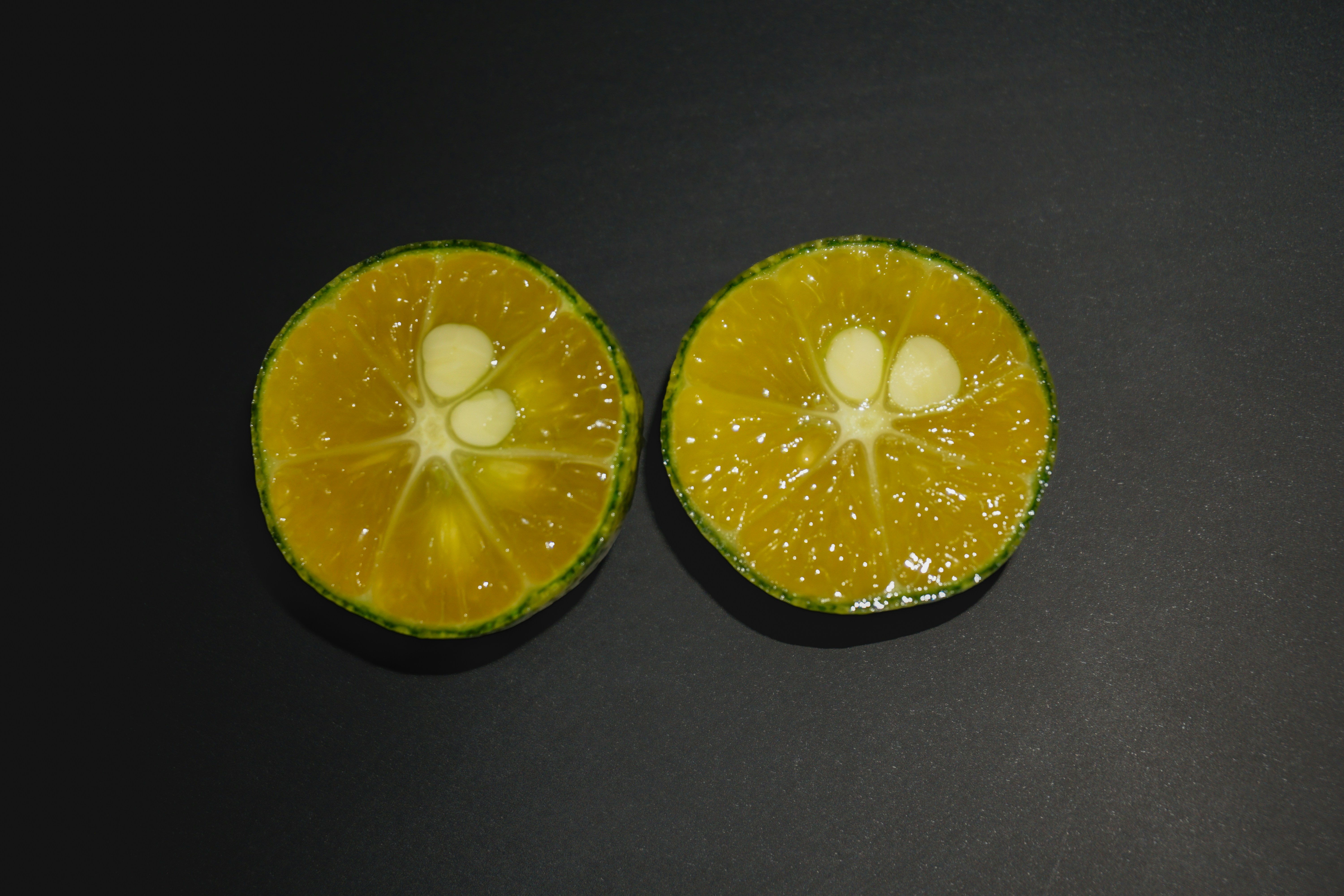 Sliced-Citrus-Elegance-by-Raju-C-Reddy A halved calamondin reveals its citrus heart in Raju C Reddy's close-up shot, marrying art with agriculture. https://rajureddy.com/