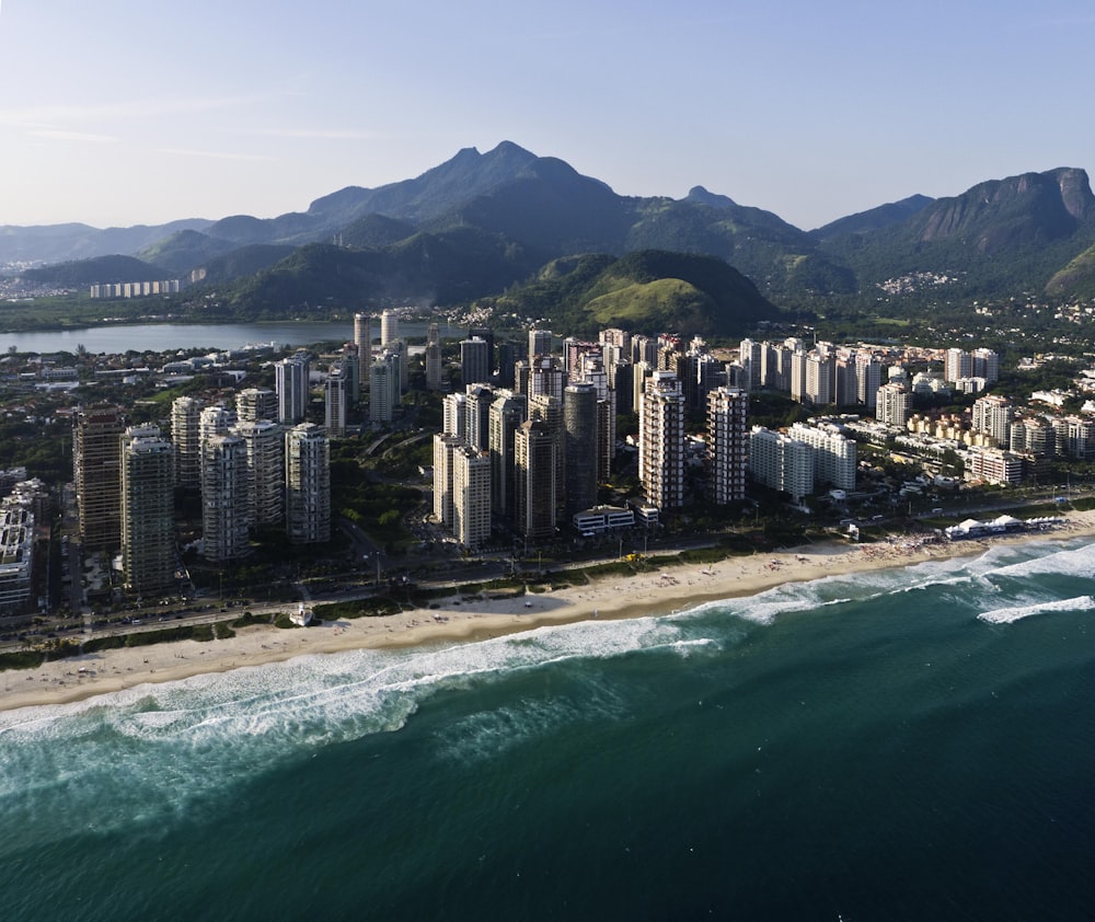 an aerial view of a city next to the ocean