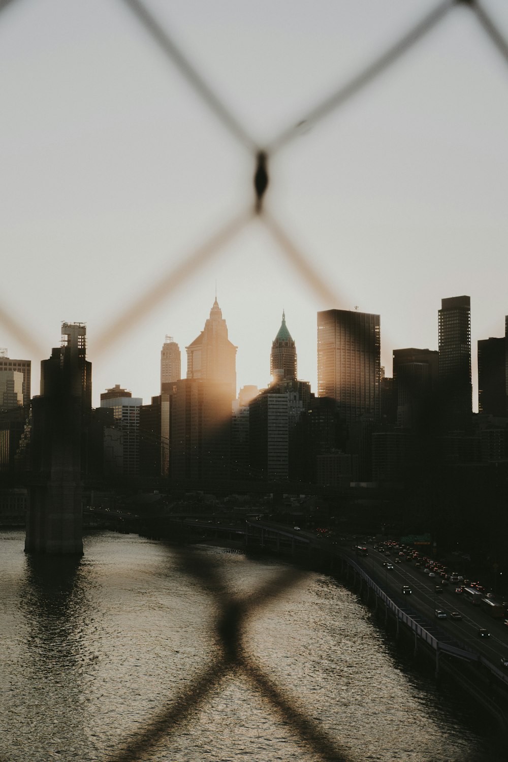 a view of a city through a fence