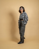 A portrait of a person standing confidently against a cosmic-themed backdrop, wearing Jam Ras clothing.