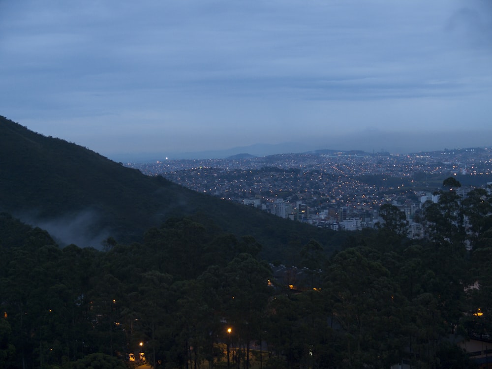 a view of a city from a hill at night