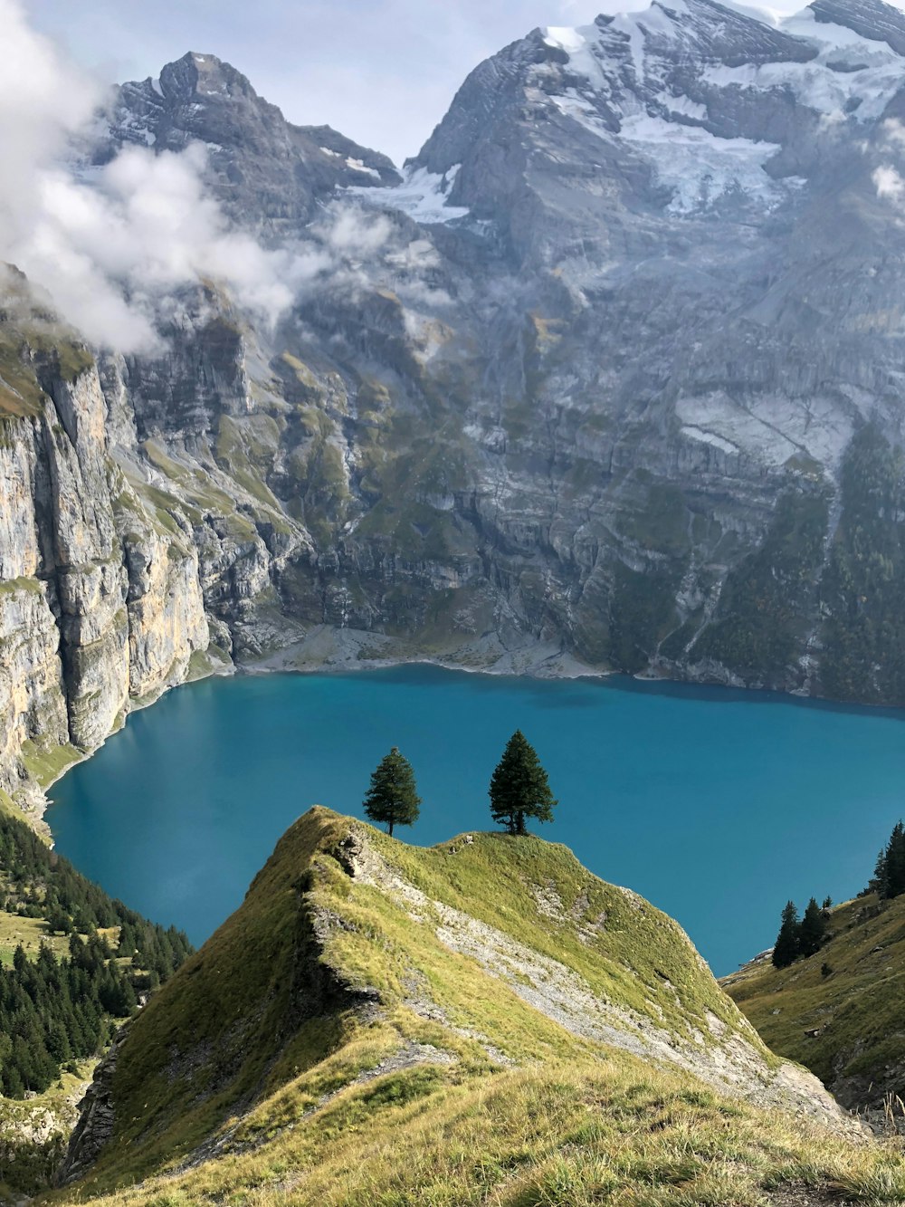 a blue lake surrounded by mountains and trees