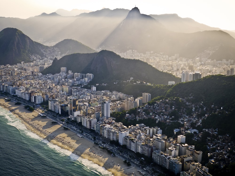 an aerial view of a city with mountains in the background