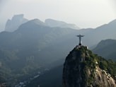 a statue of jesus on top of a mountain