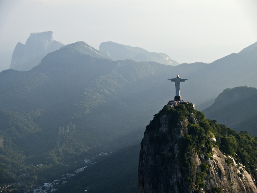 a statue of jesus on top of a mountain