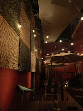 Warm, colorful outdoor seating area decorated with vintage Colombian textiles and lights.