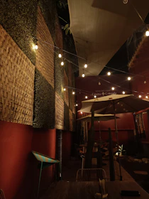 Warm, colorful outdoor seating area decorated with vintage Colombian textiles and lights.