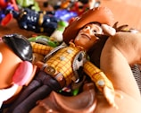 a toy cowboy laying on top of a wooden table
