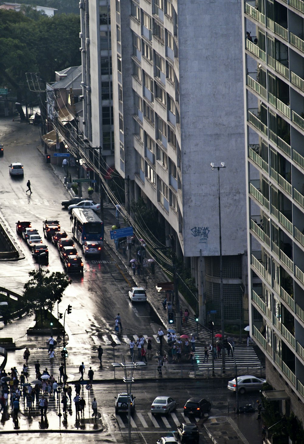 a city street filled with lots of traffic next to tall buildings