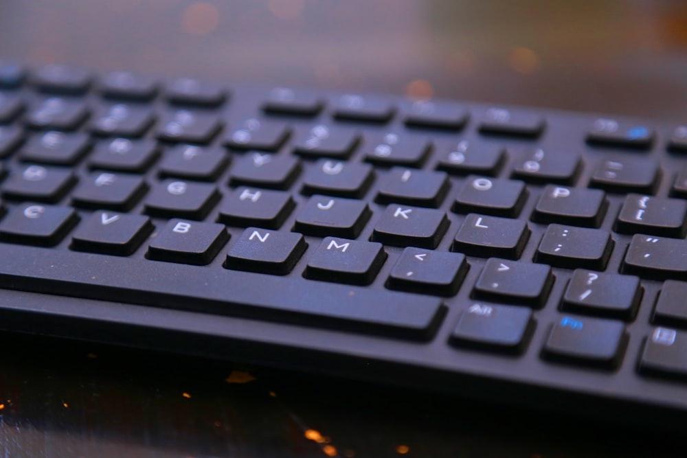 a black keyboard sitting on top of a table