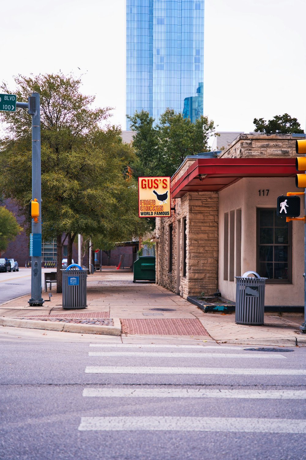 a street corner with a bus stop and a building in the background