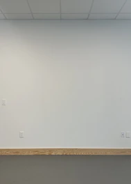 Sanitary baseboards installed along a clean factory wall.