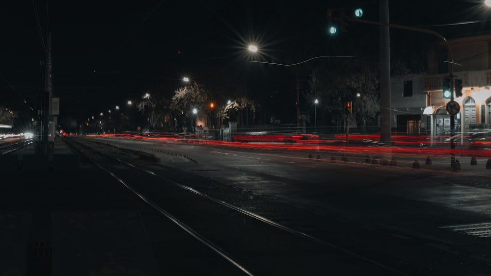 a city street at night with traffic lights