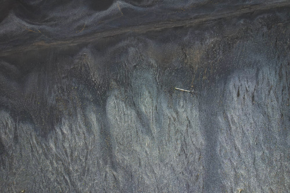 a close up of a rock wall with grass growing on it