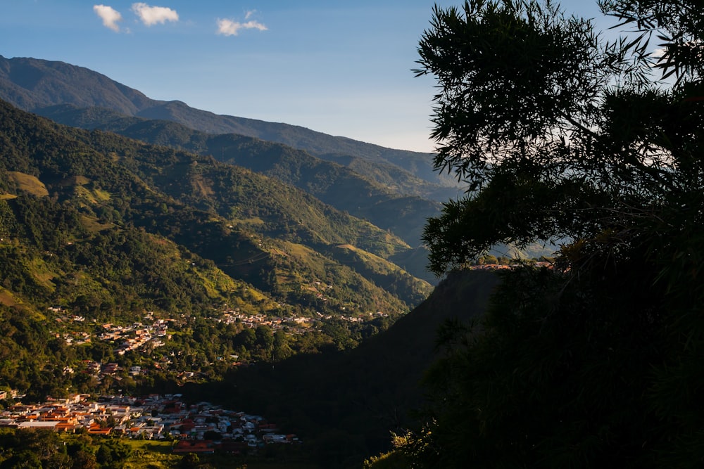 a view of a town nestled in the mountains