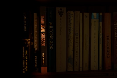 a bookshelf filled with lots of books in a dark room