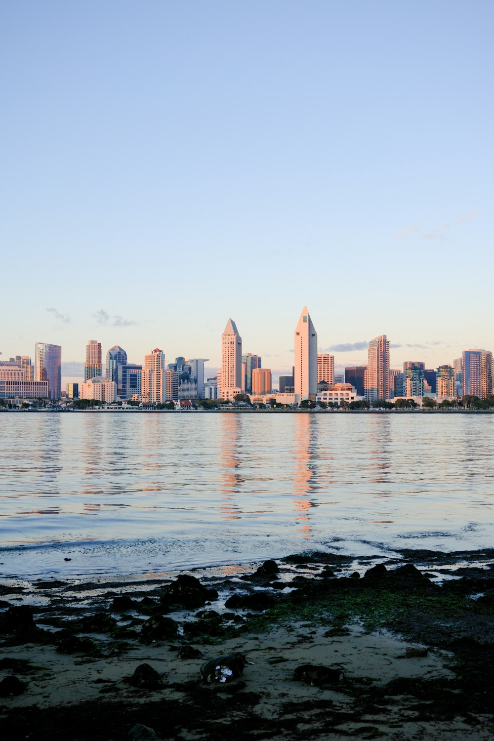 a large body of water with a city in the background