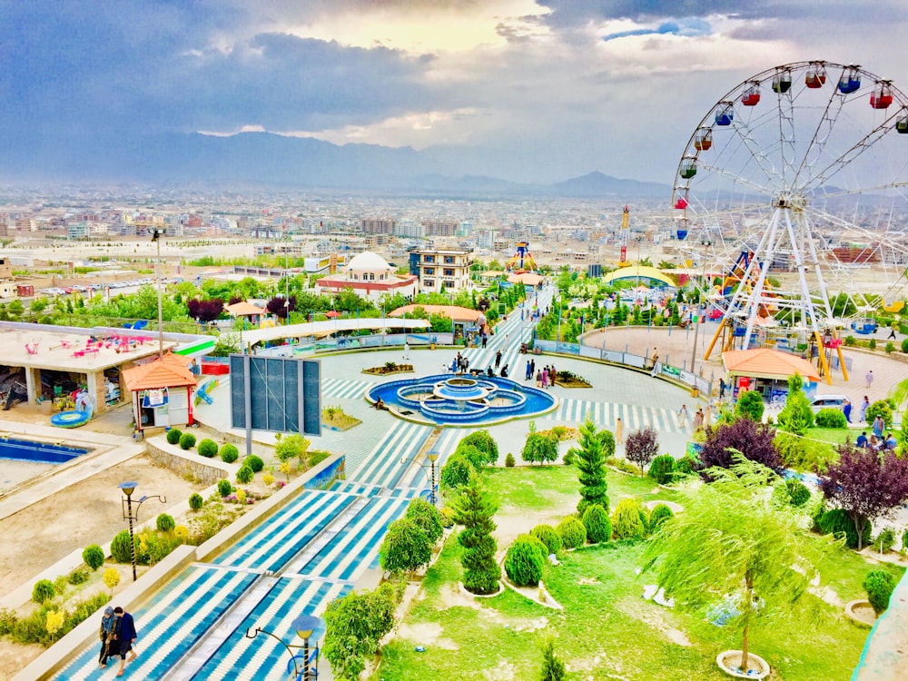 an aerial view of a carnival park with a ferris wheel