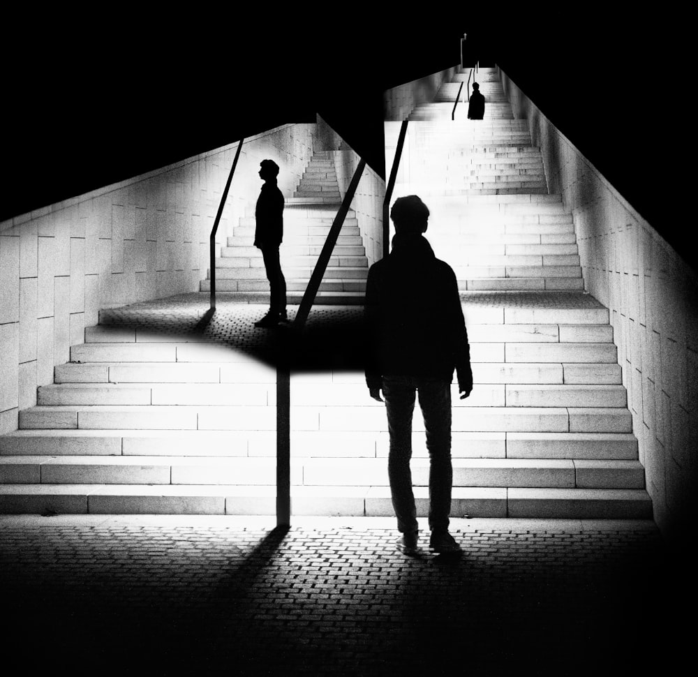 a man standing in front of a stairway at night