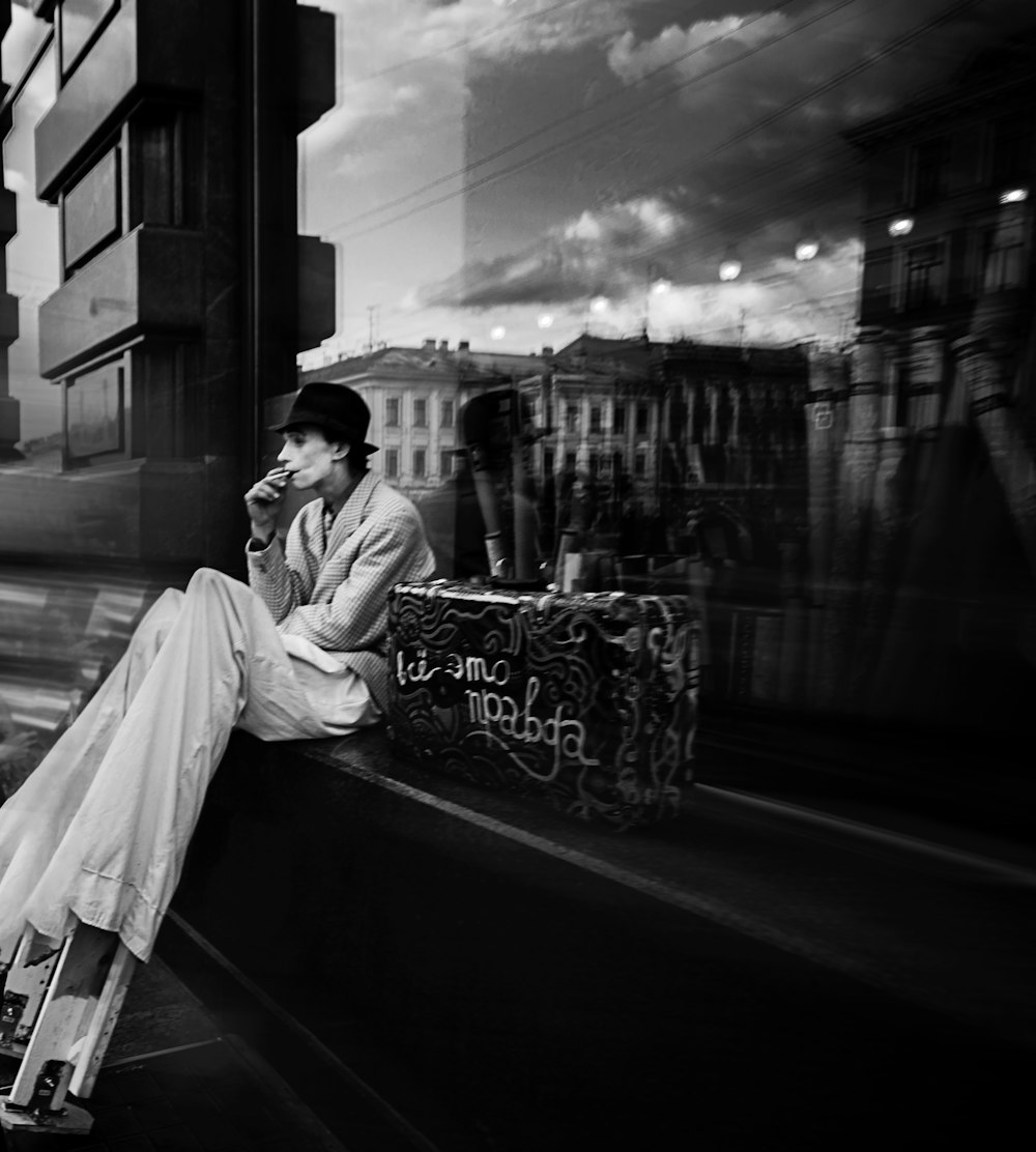 a man sitting on a bench talking on a cell phone