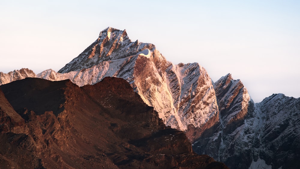 a large mountain with a snow covered peak