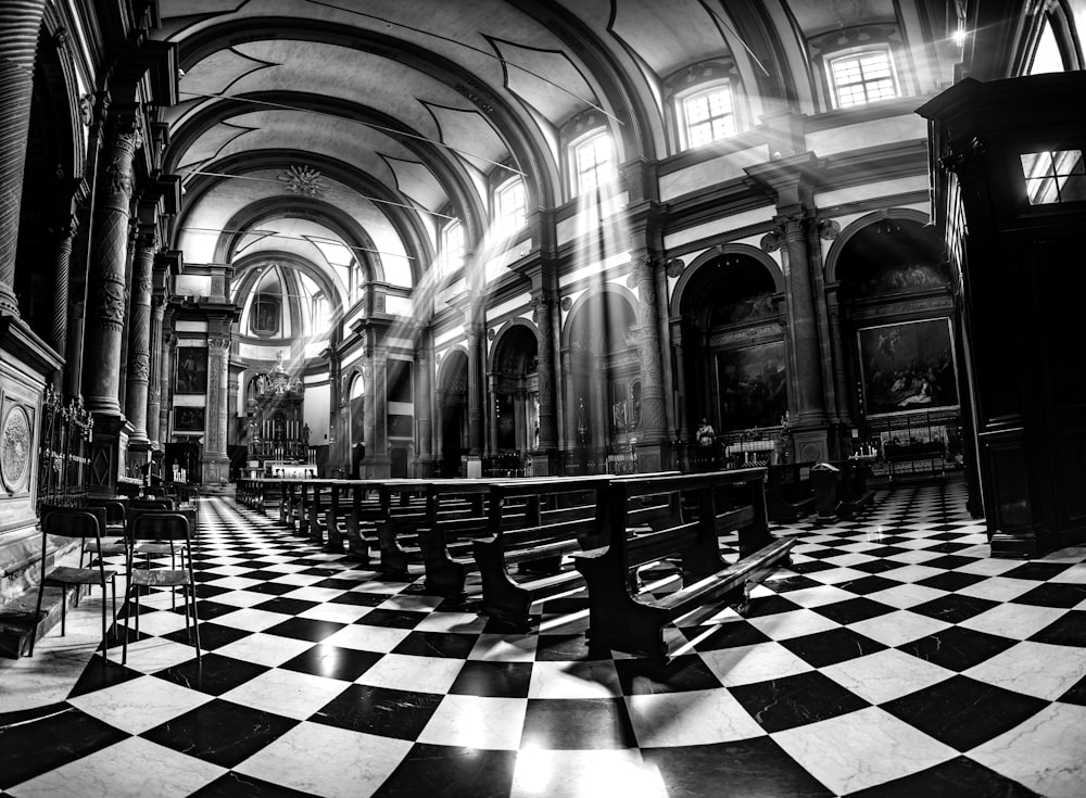 a black and white photo of a church with a checkered floor