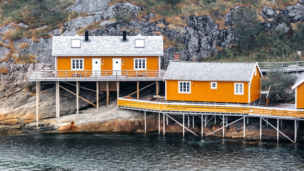 a couple of houses sitting on top of a pier