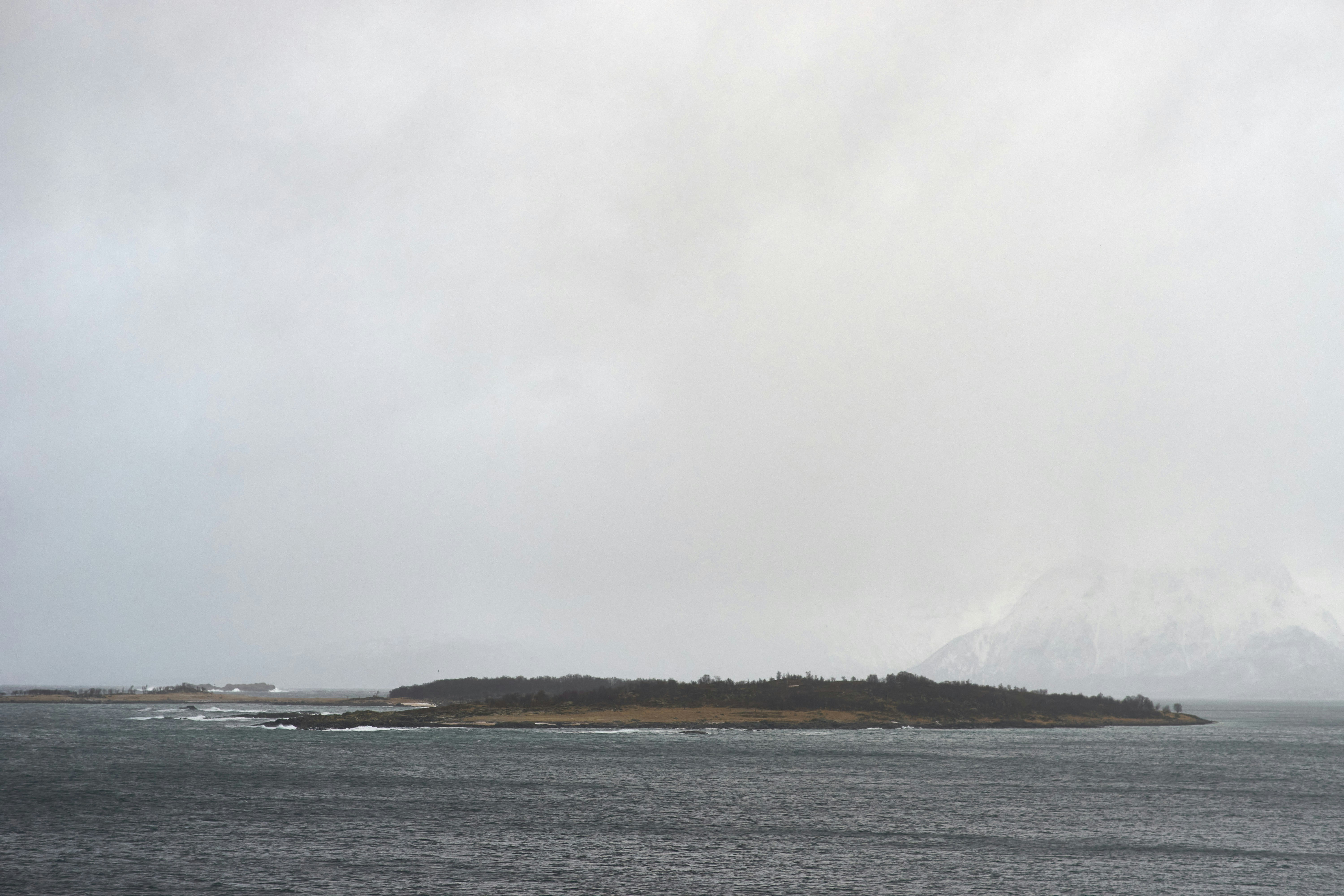a large body of water with a small island in the middle of it