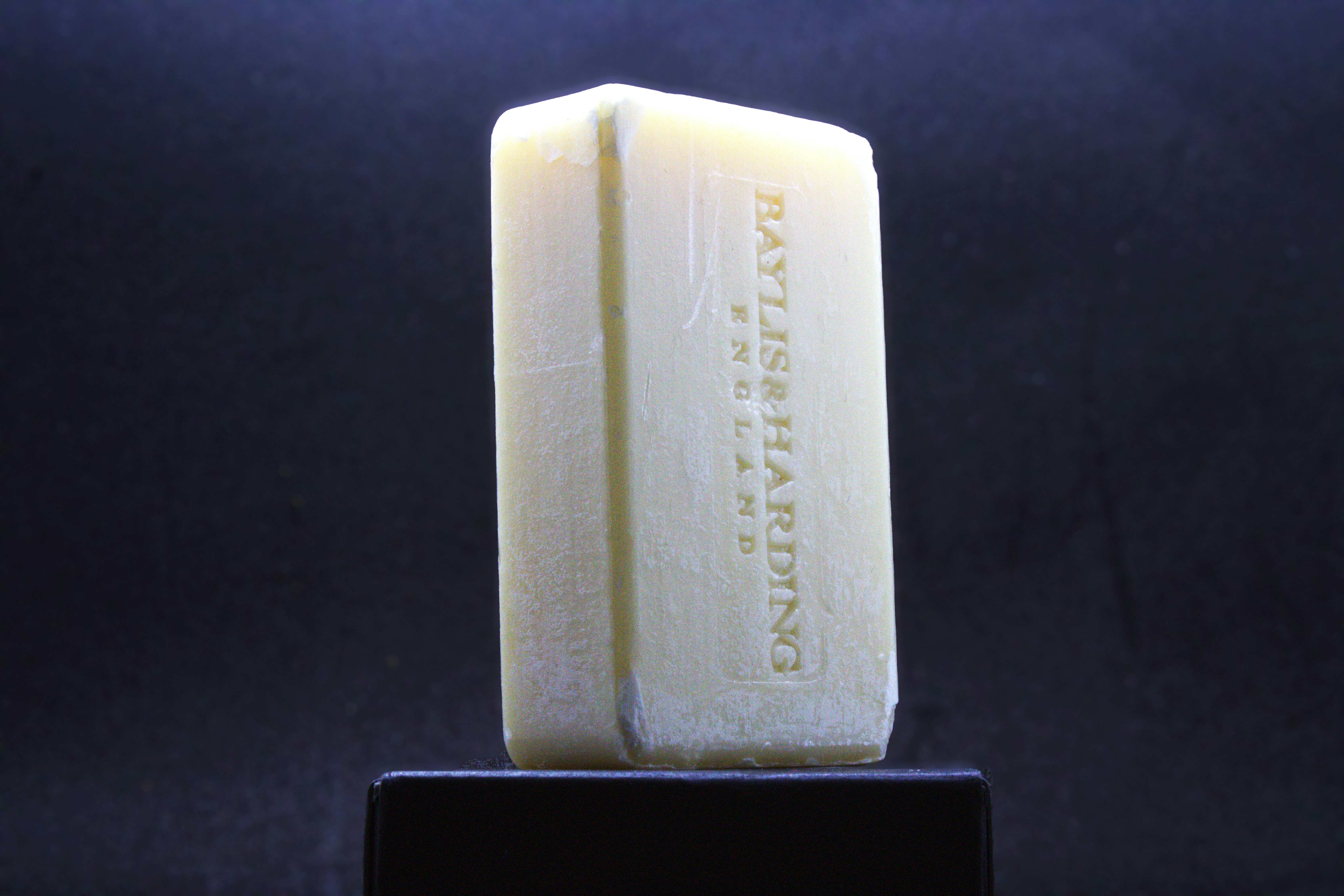 a bar of soap sitting on top of a black stand