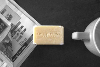 a bar of soap sitting next to a cup of coffee
