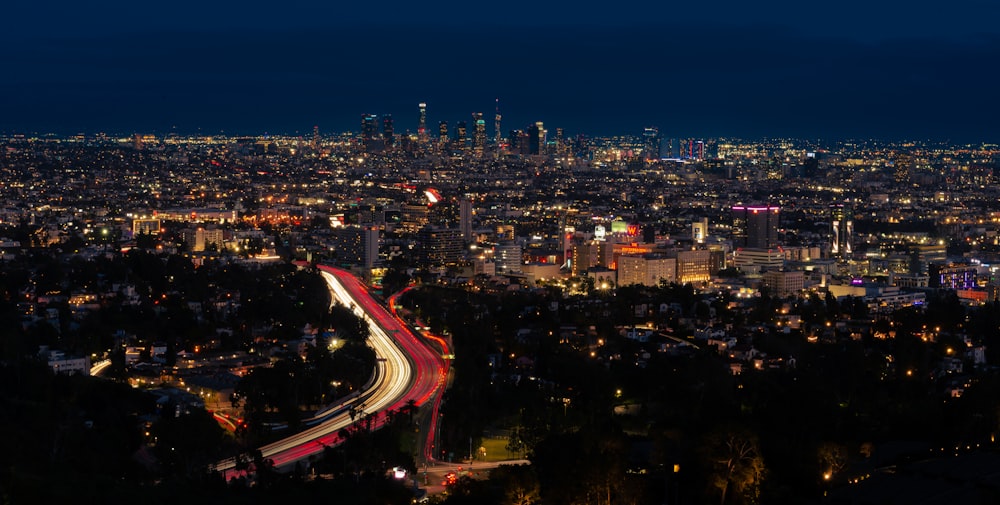 a view of a city at night from a hill