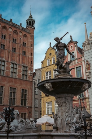 Close-up of a licensed guide sharing stories near the iconic Neptune Fountain in Gdansk.