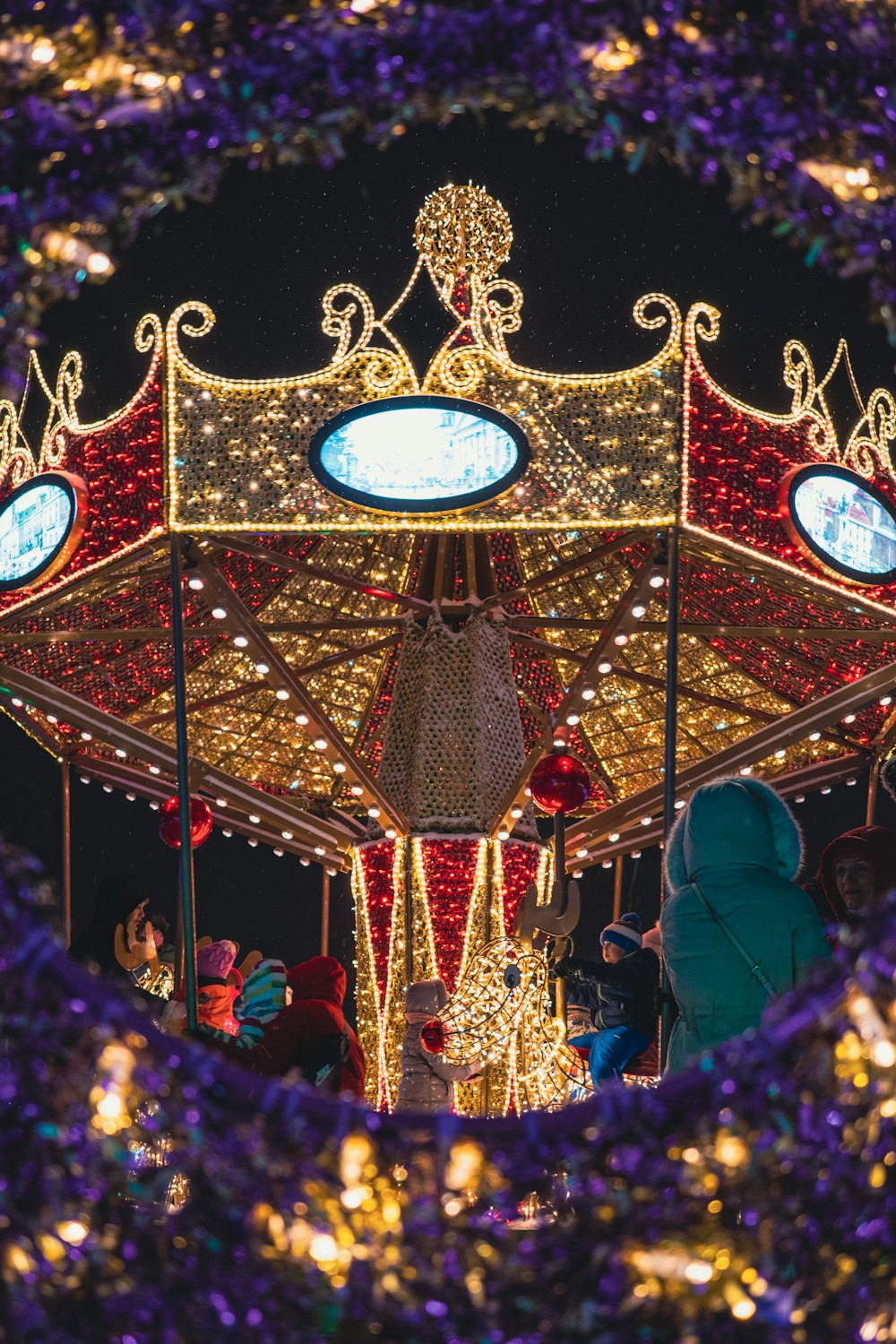 a merry go round with lights and decorations