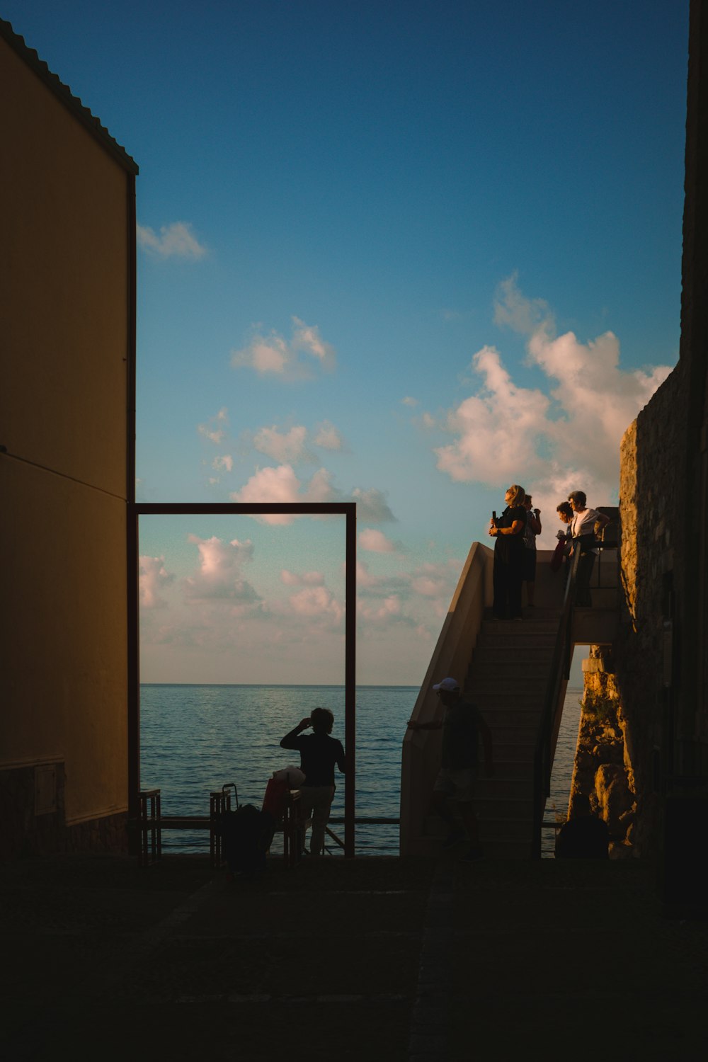 a group of people standing on top of a set of stairs