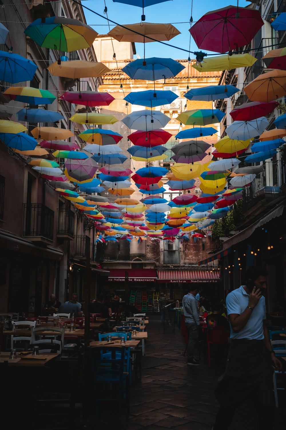 a bunch of umbrellas that are hanging in the air