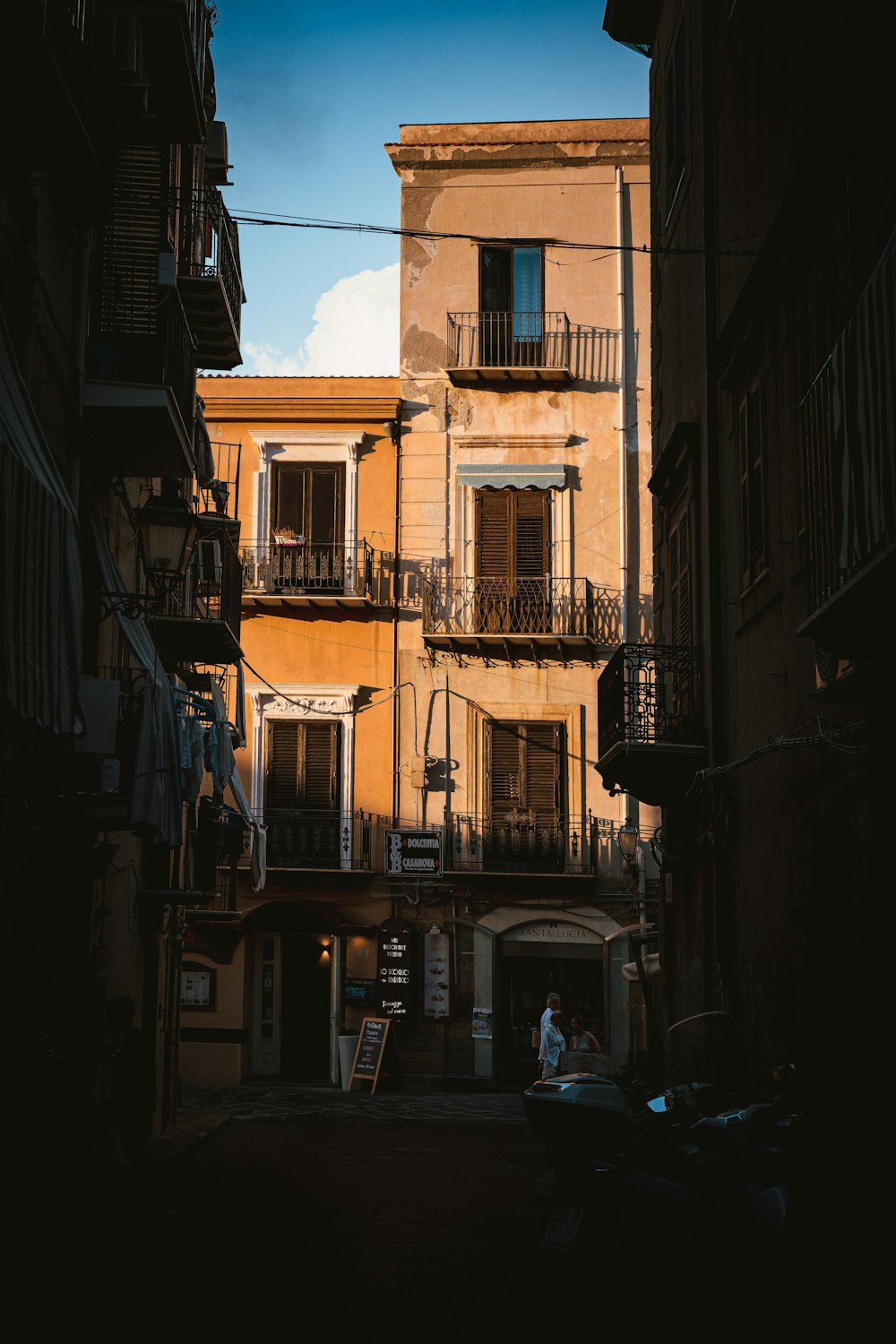 a narrow alley way with a building in the background