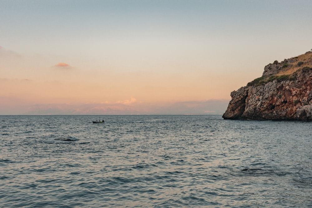 a small boat in the middle of a large body of water