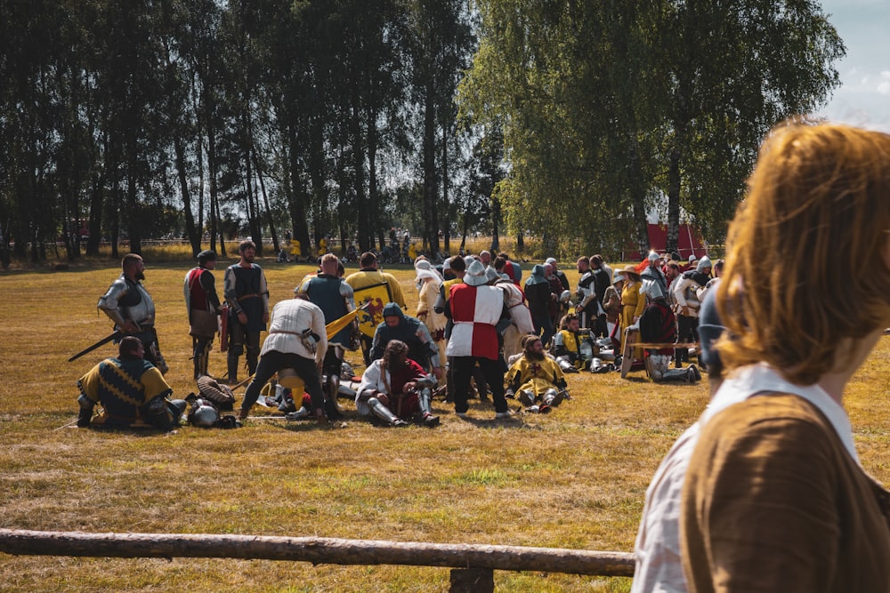 a group of people standing in a field