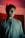 a man standing in a room with a red light